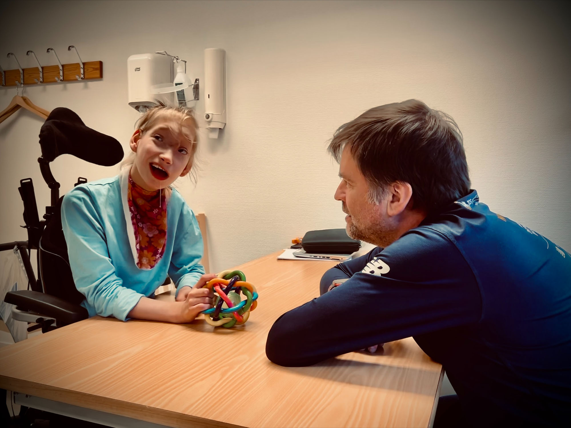 Two light-skinned people face each other at a table.