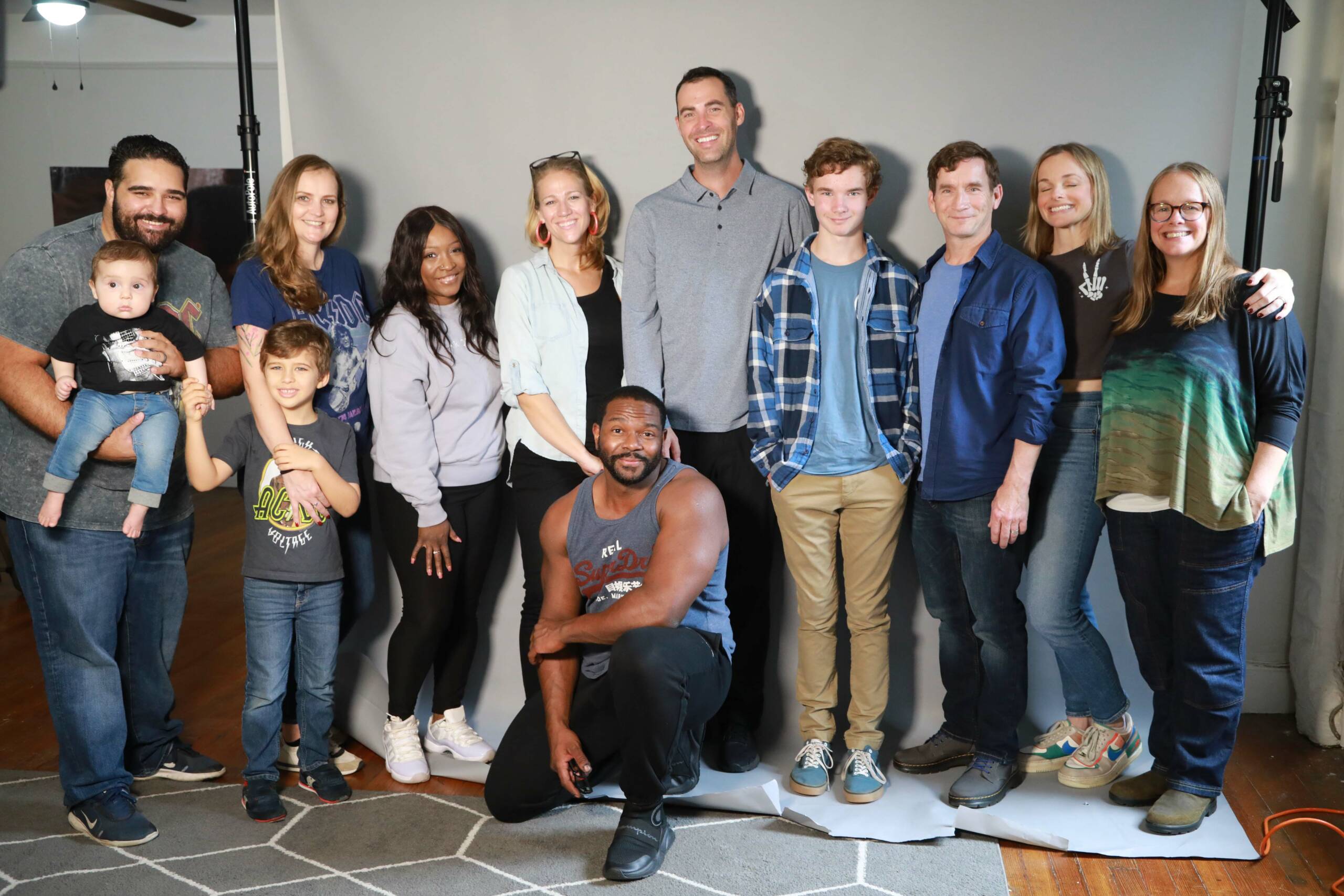 Group of people of all ages smiling and looking into the camera