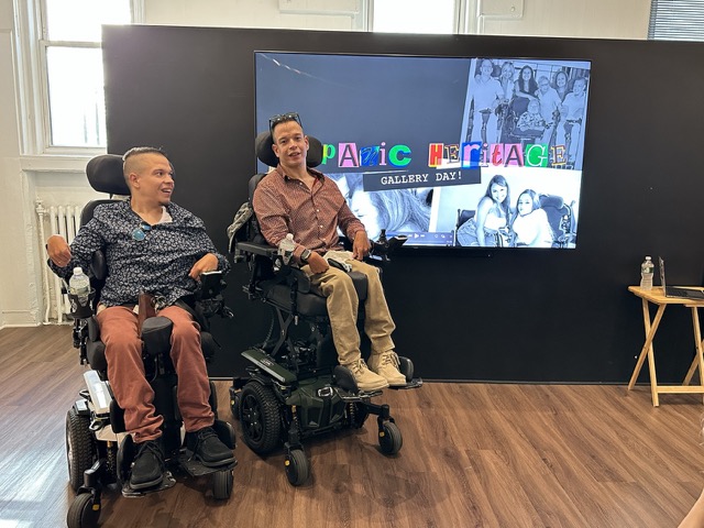 IMG_0508 Medium Twin young men in wheelchairs addressing a crowd int he gallery.