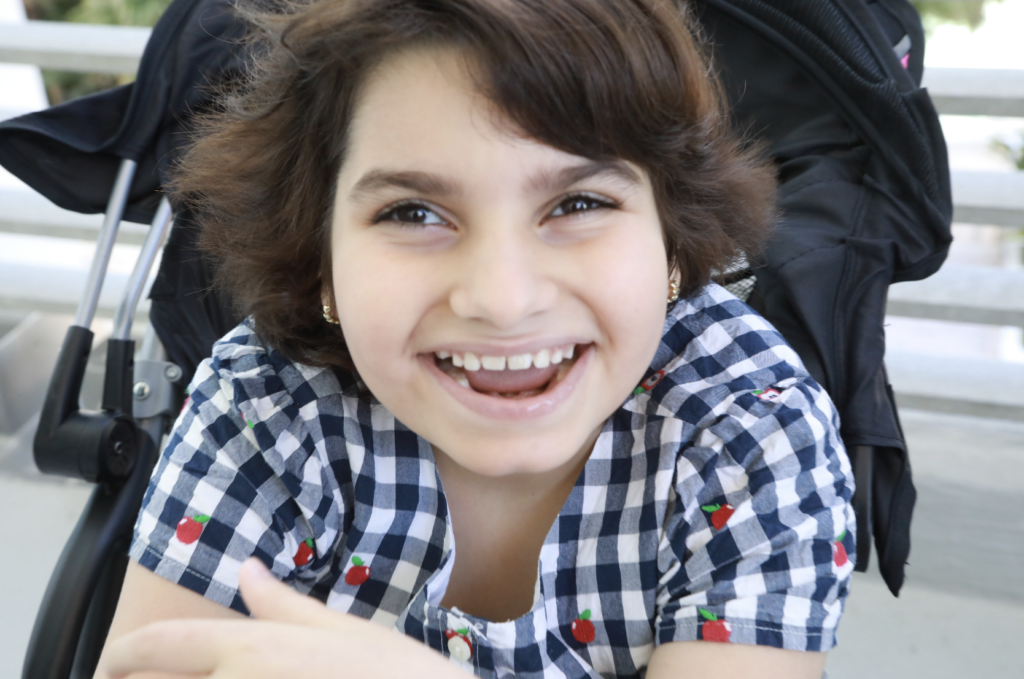 Beautiful young girl with brown hair smiling into the camera
