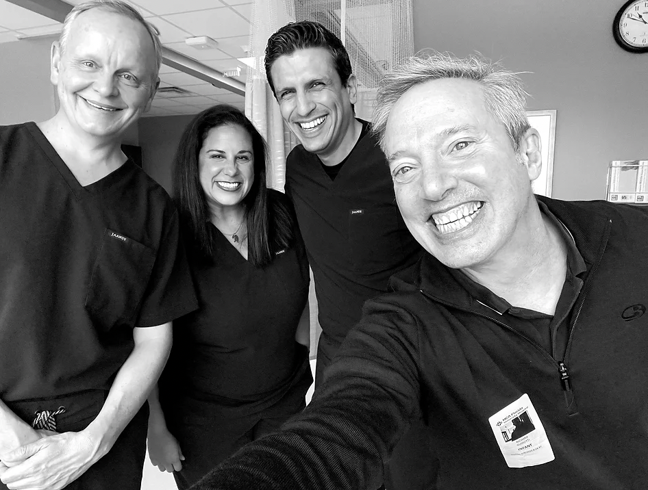3 Neo anthologists in scrubs with photographer smiling into the camera.