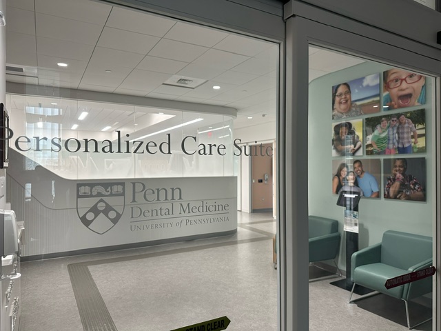 waiting room through the glass and photographs of Positive Exposure on the wall.