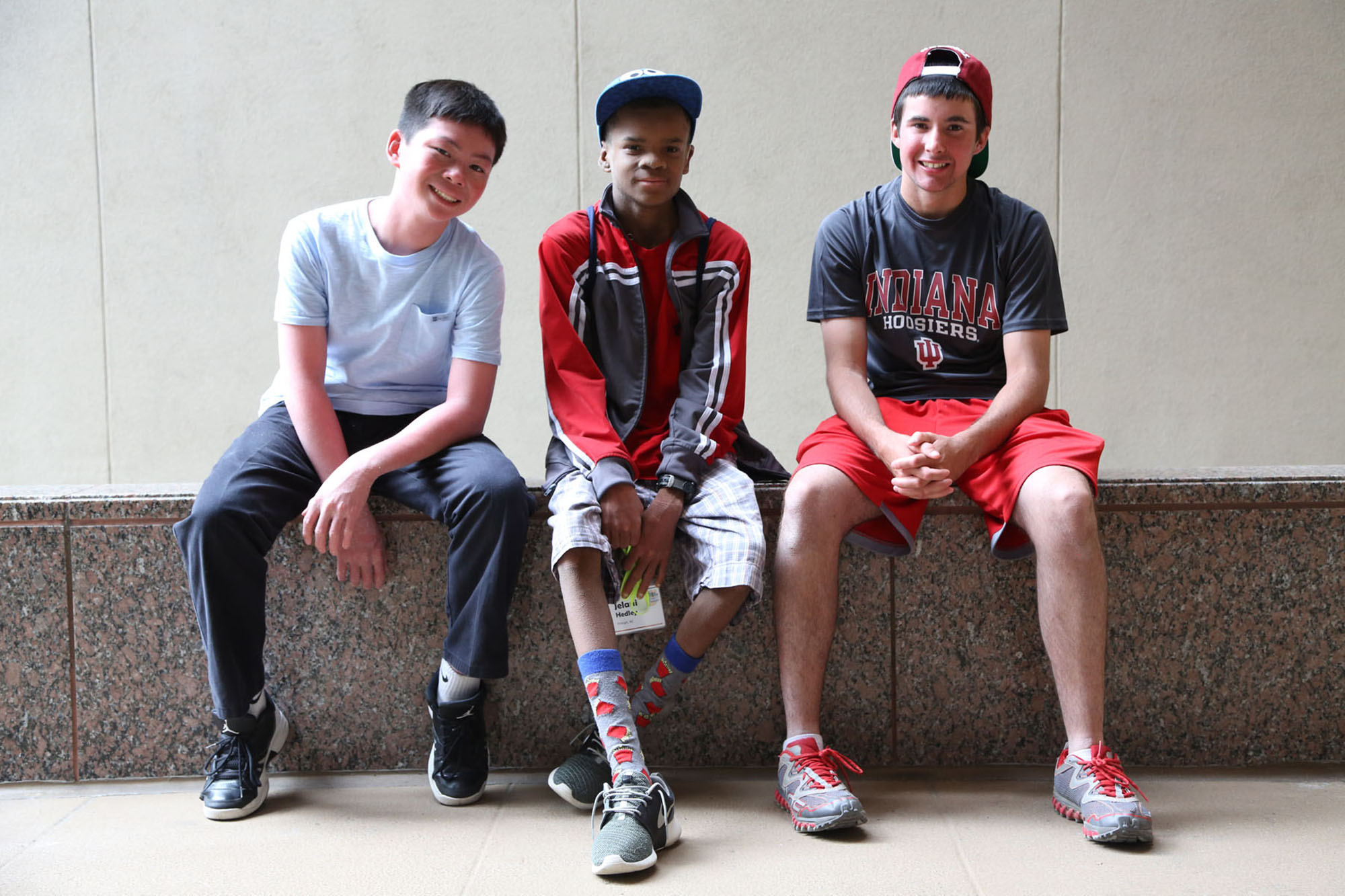 Three boys that all have Ichthyosis ARCI-lamellar sit together and pose for a photo