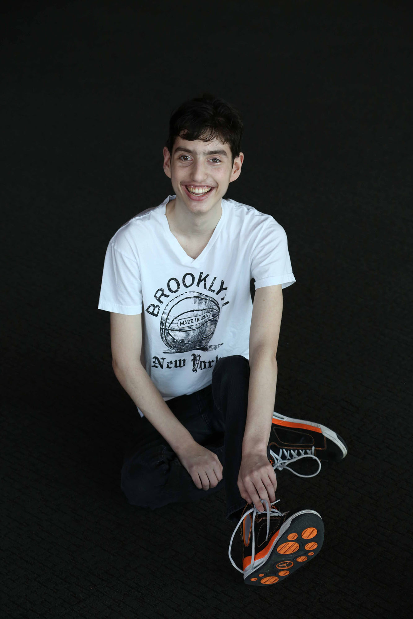 Young man with Familian Dysautonomia sitting down posing for a picture.