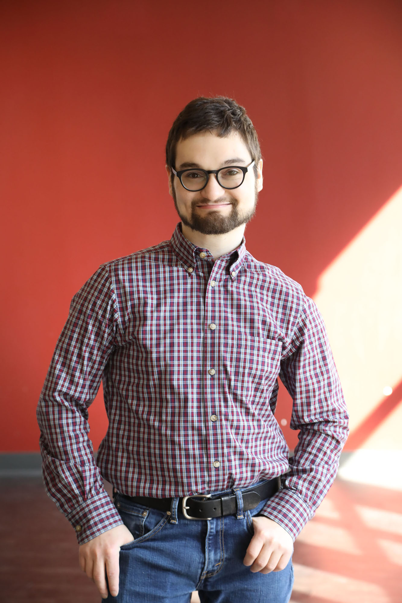 Man with Familial Dysautonomia wearing button up and looking into camera.