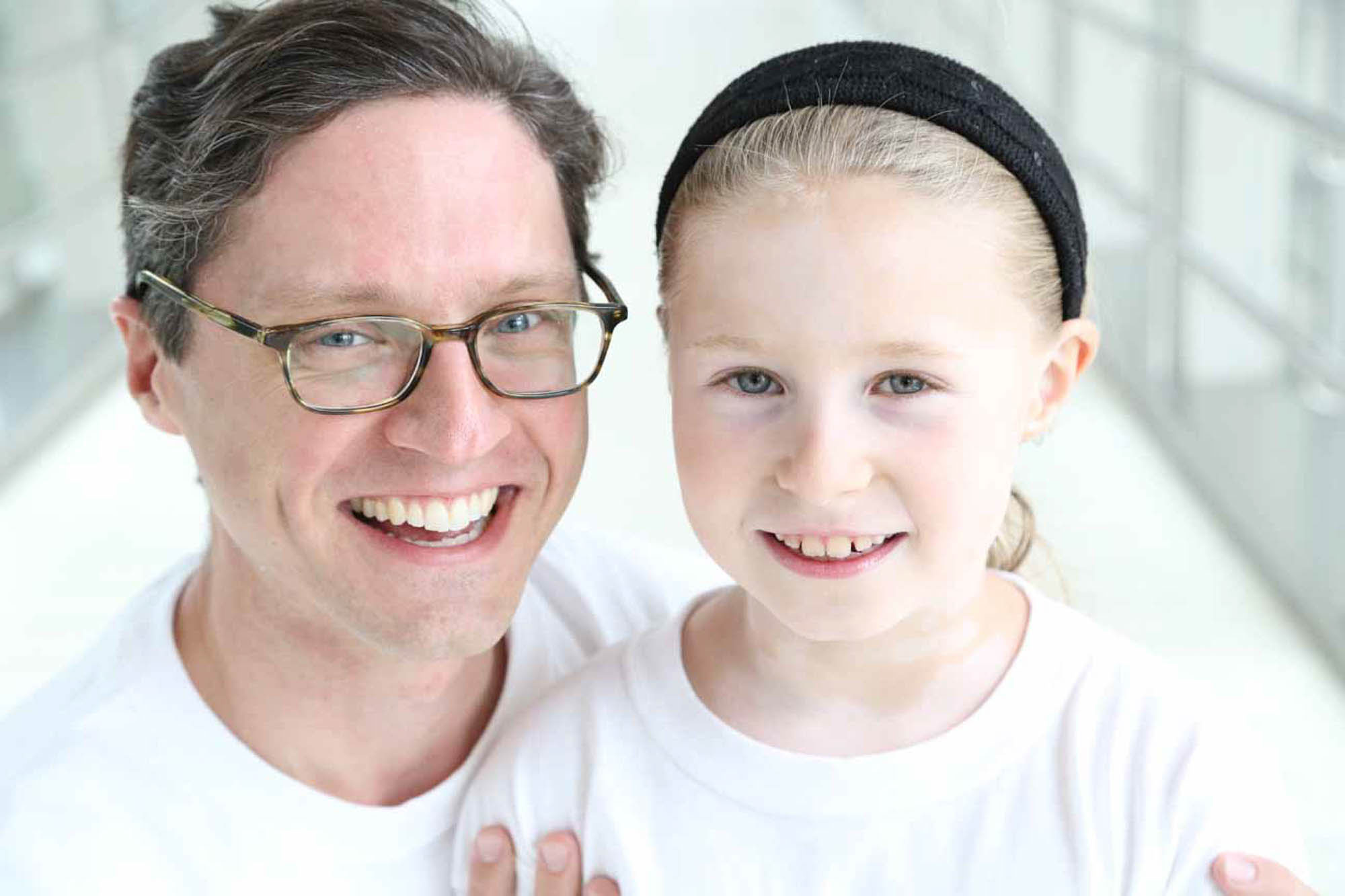 girl with Vitiligo standing next to her dad