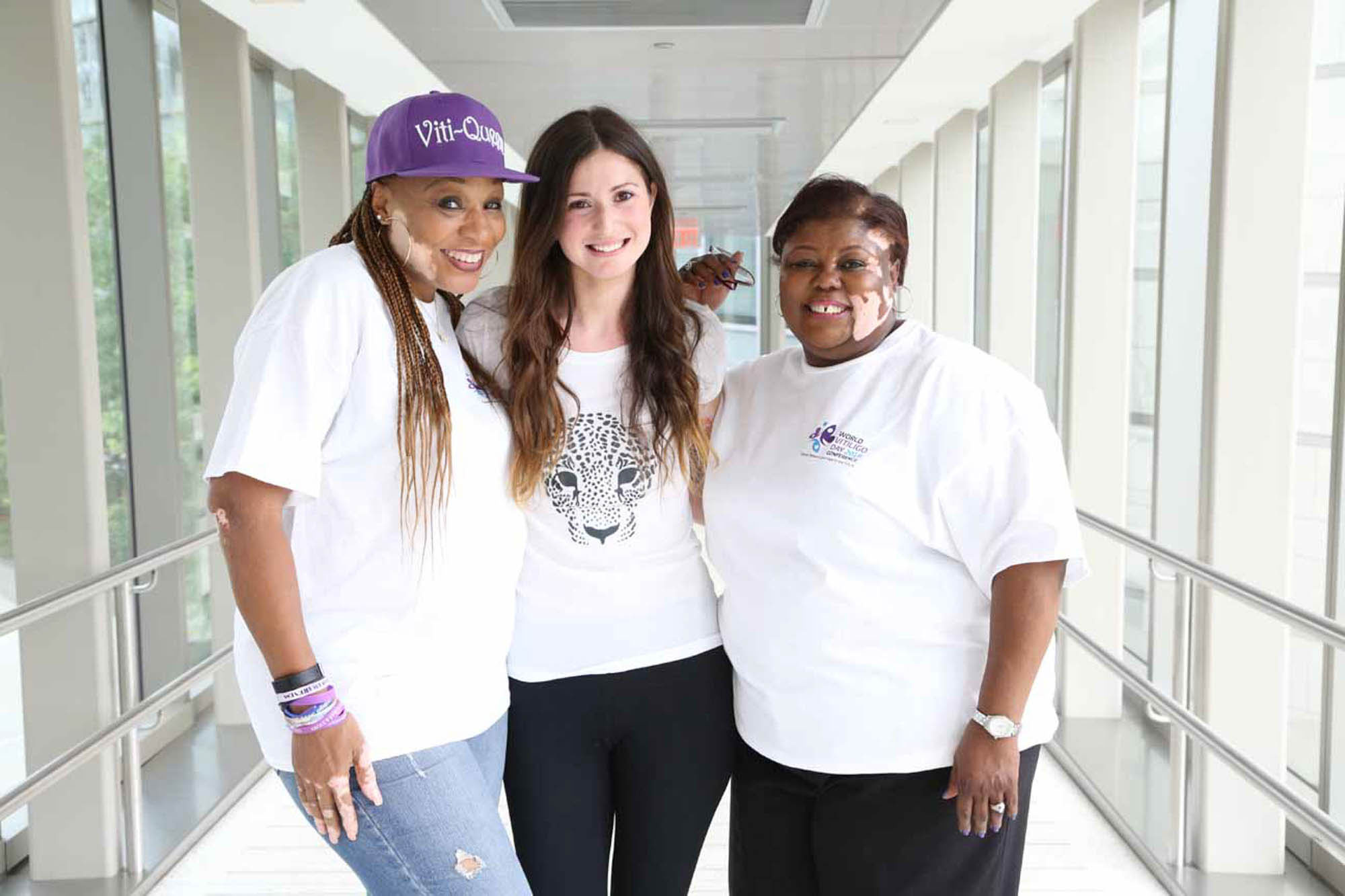 three women with Vitiligo hug eachother in photo