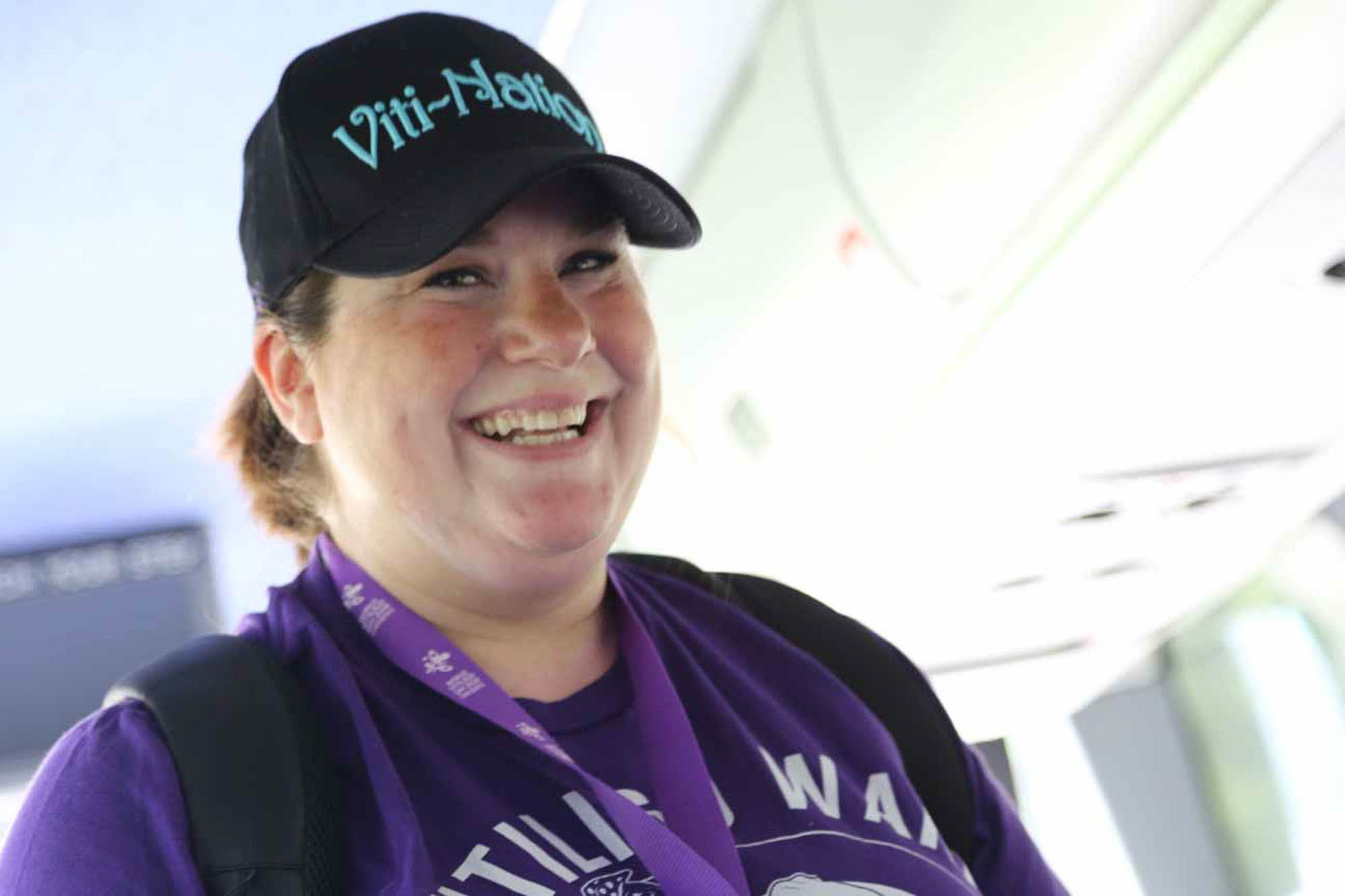 woman with vitiligo wearing purple and smiling
