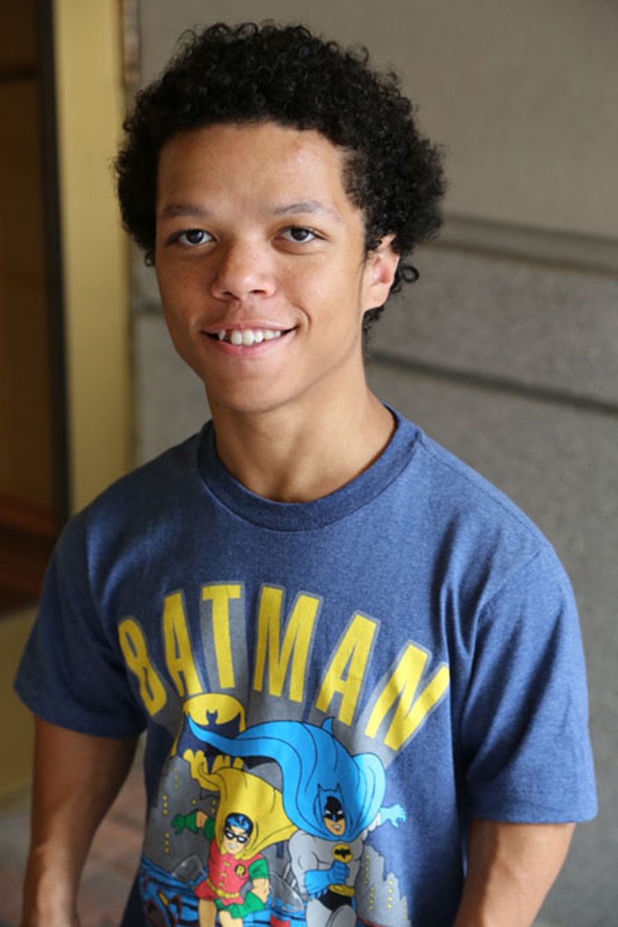 boy with skeletal dysplasia wearing batman shirt and smiling