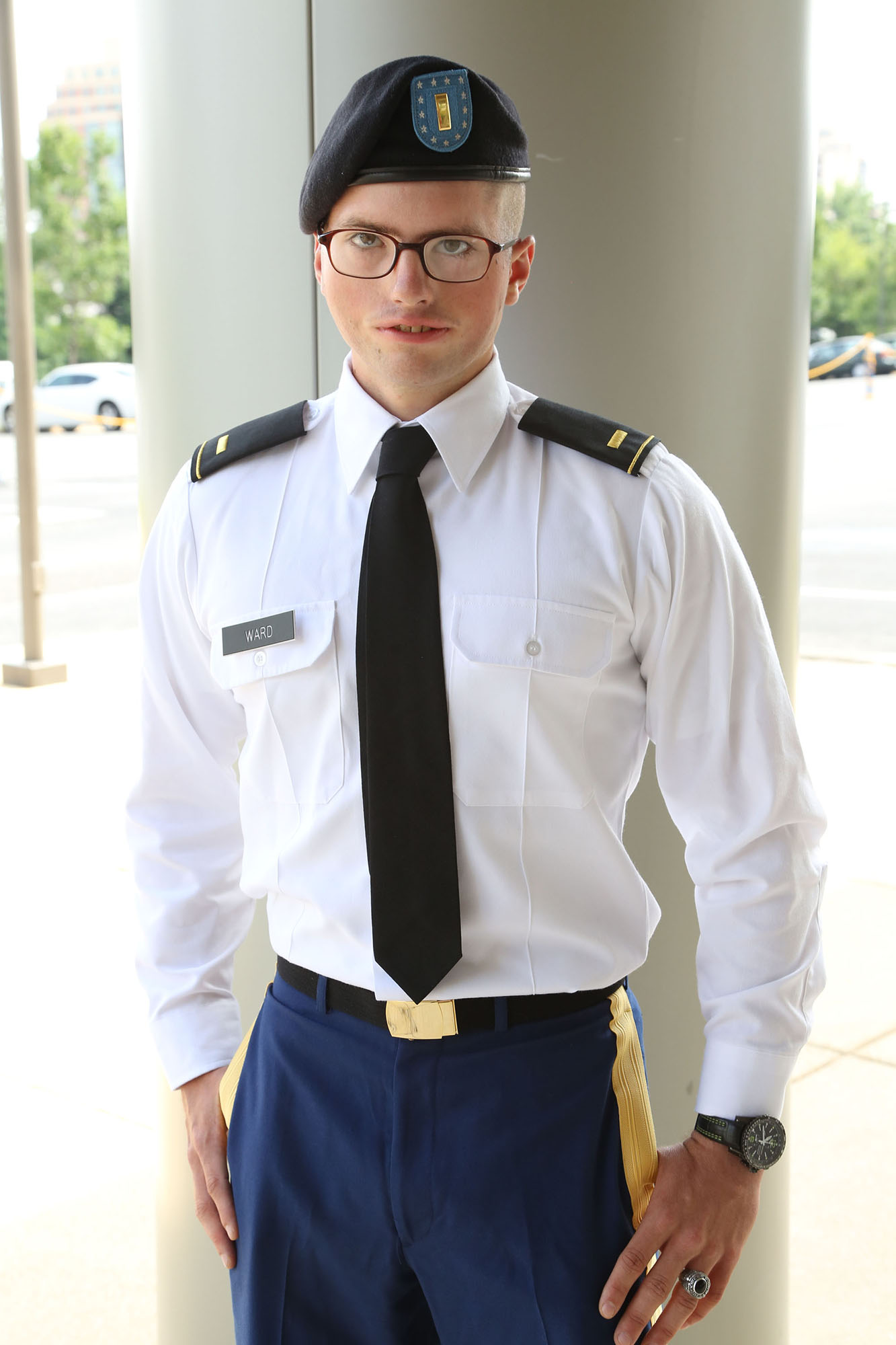 young man with moebius syndrome wearing military clothes