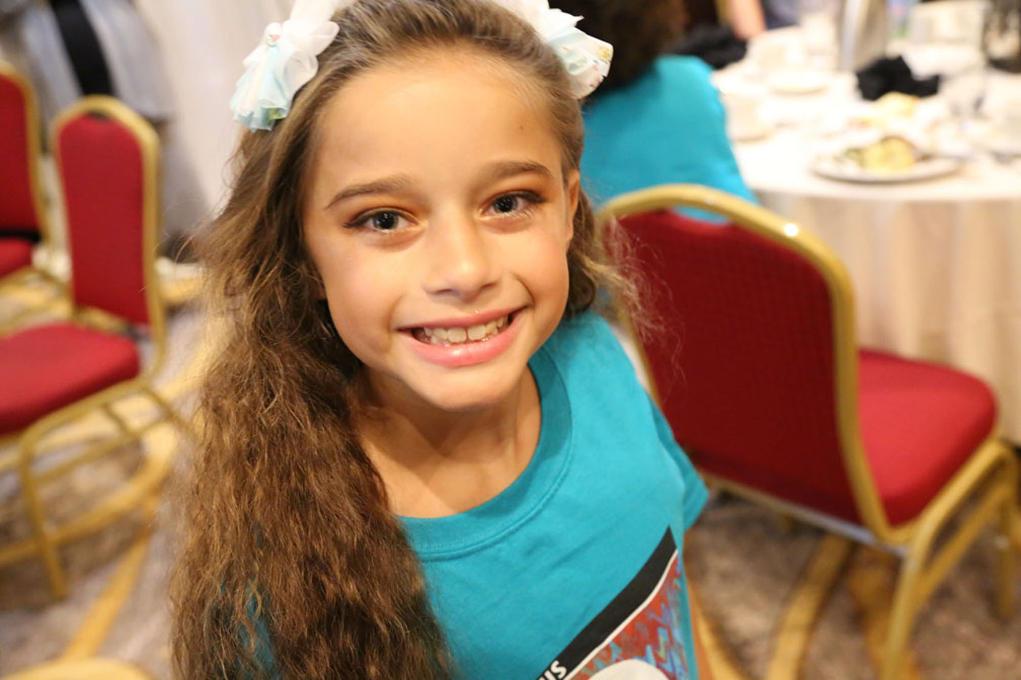 young girl with klippel trenaunay syndrome smiling at the camera