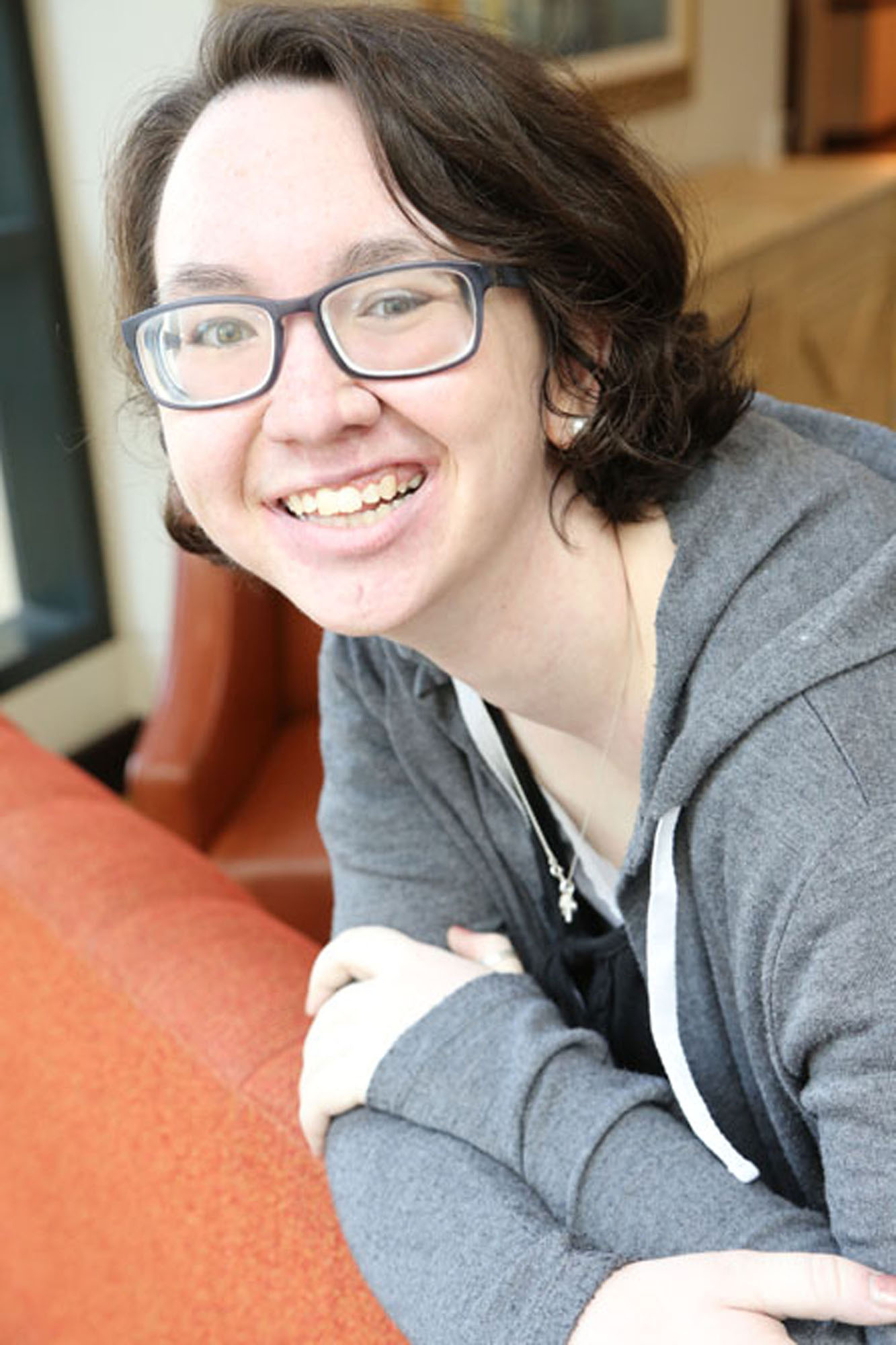 girl with klippel trenaunay syndrome wearing glasses smiles at the camera