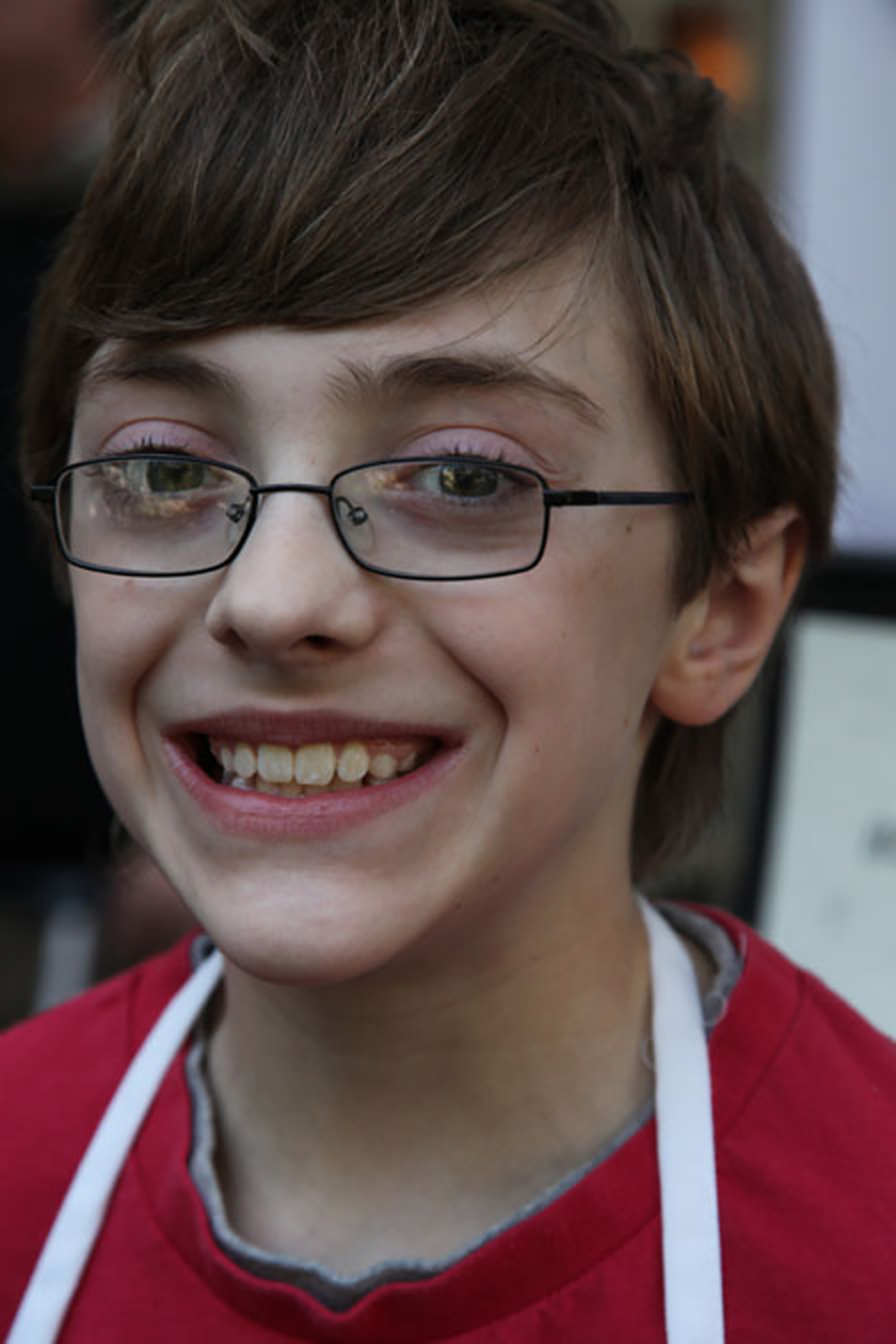 boy with dravet syndrome smiling at camera, wearing glasses