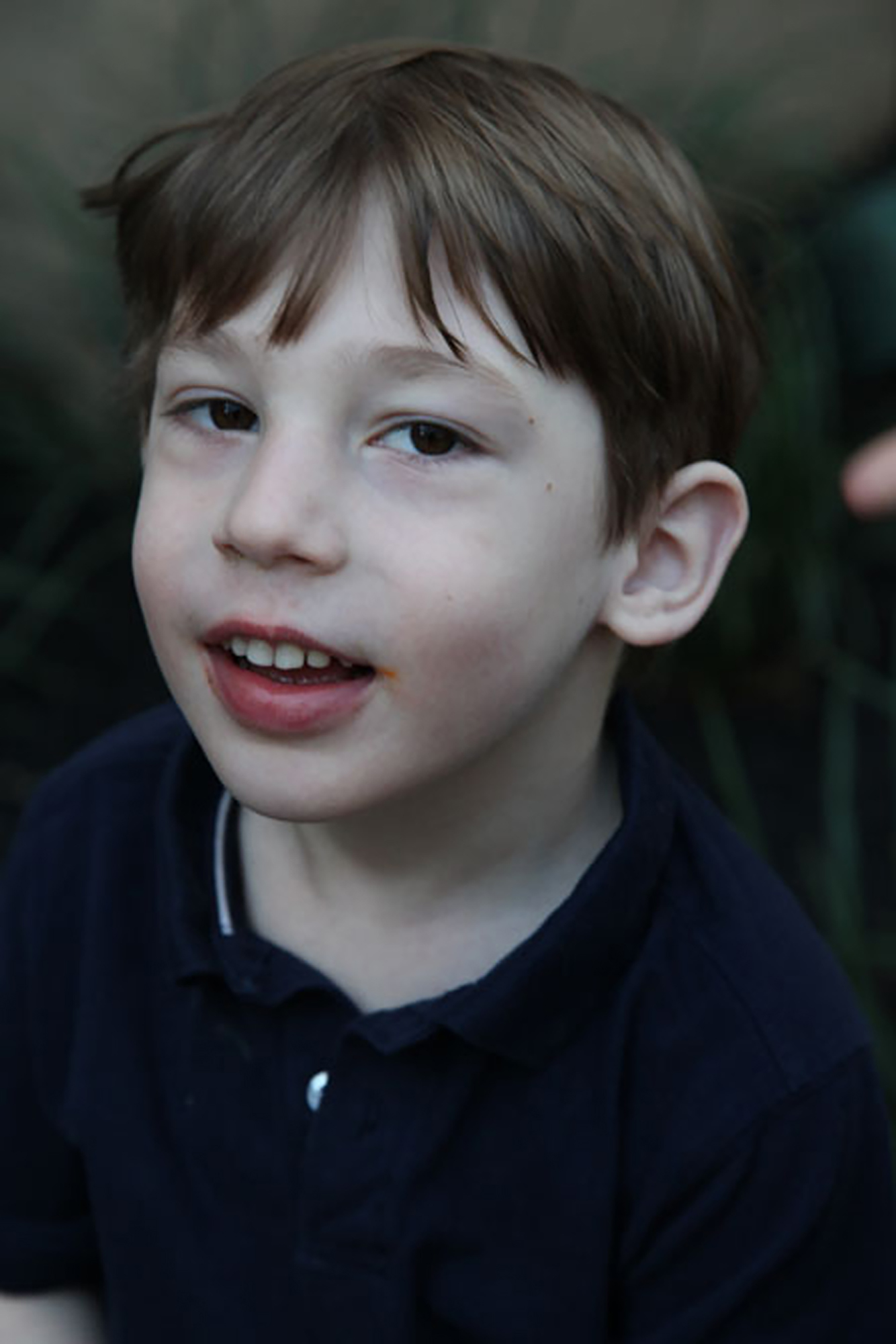 young boy with dravet syndrome looks into camera