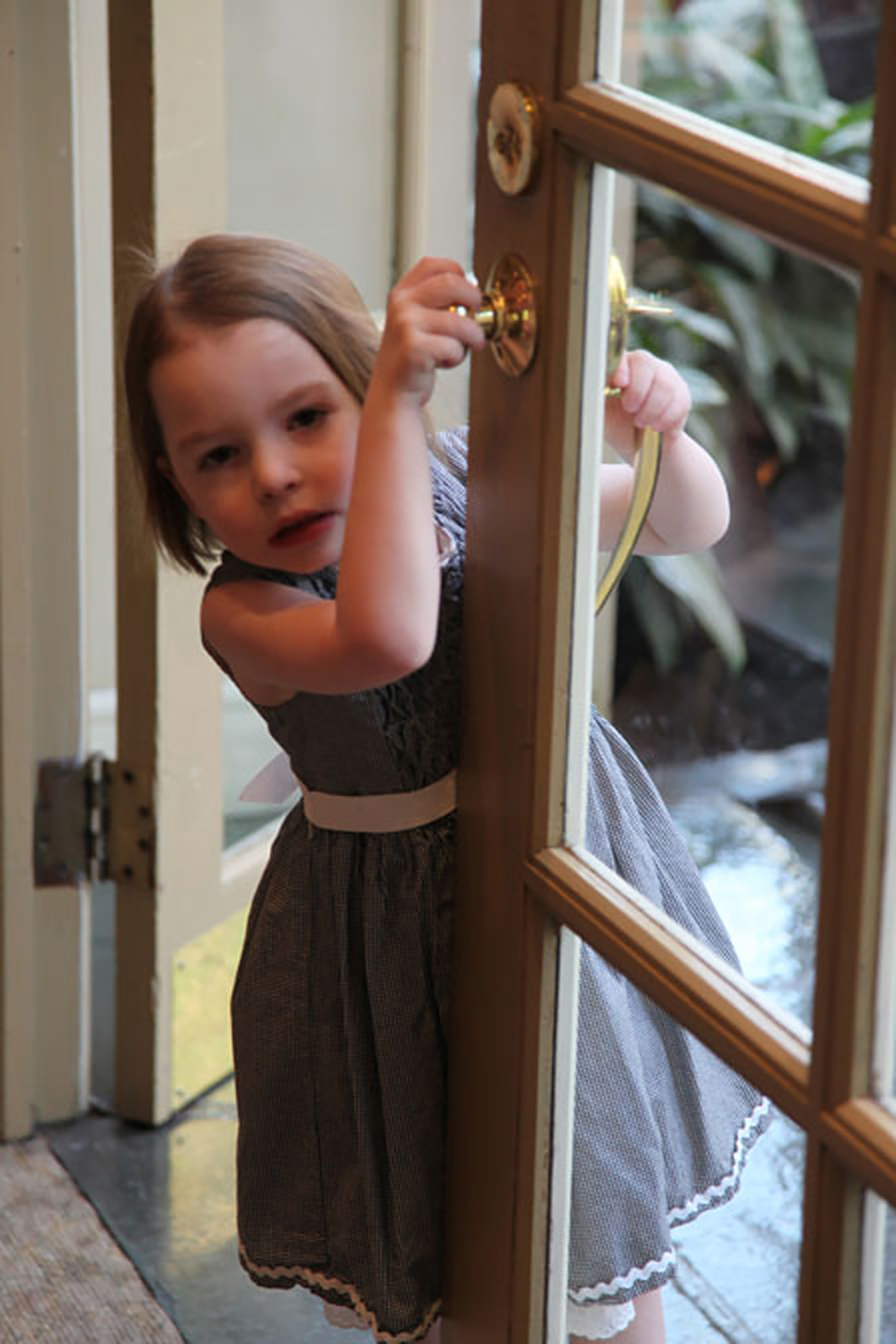 young girl with dravet syndrome leaning on doorway