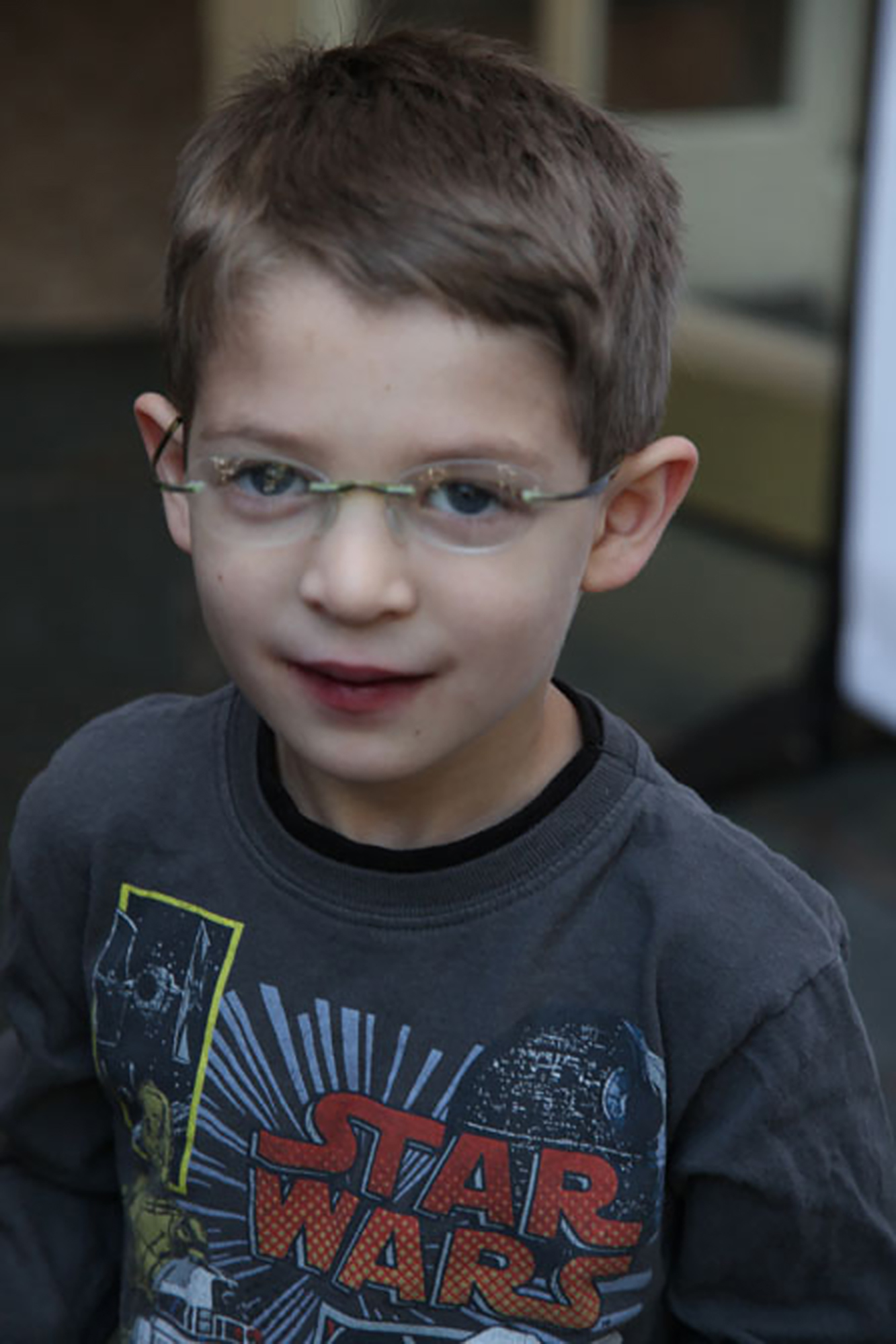 young boy with Dravet syndrome wearing glasses and star wars shirt