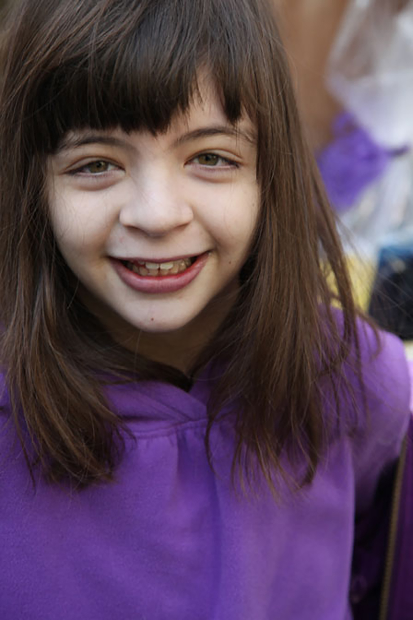 young girl with dravet syndrome wearing purple shirt looking at camera