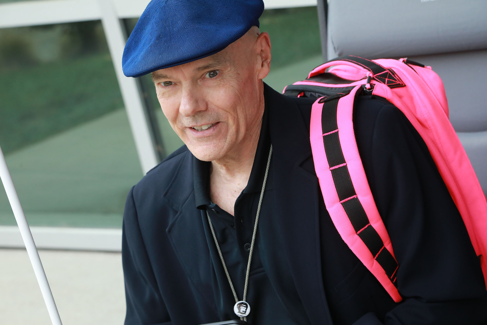 AX2A9862 Man is dark blazer with blue beret holding a white cane and looking into the camera.