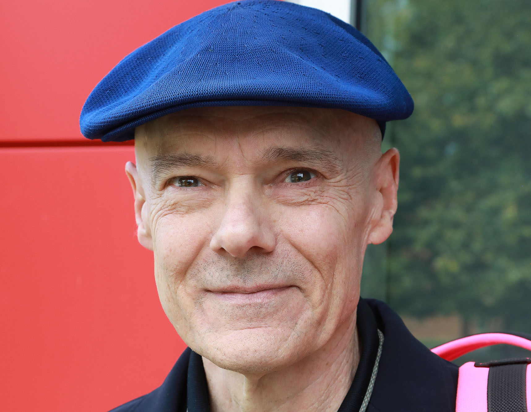 AX2A9601 Man is dark blazer with blue beret looking into the camera.