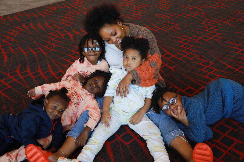 5 boys and mon sitting and lounging on the floor