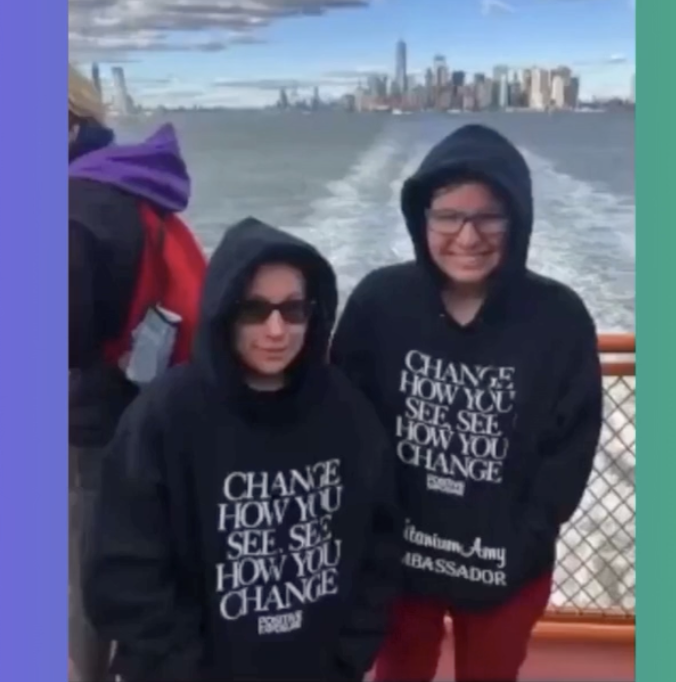 2 ladies on a boat, nyc skyline in the background.