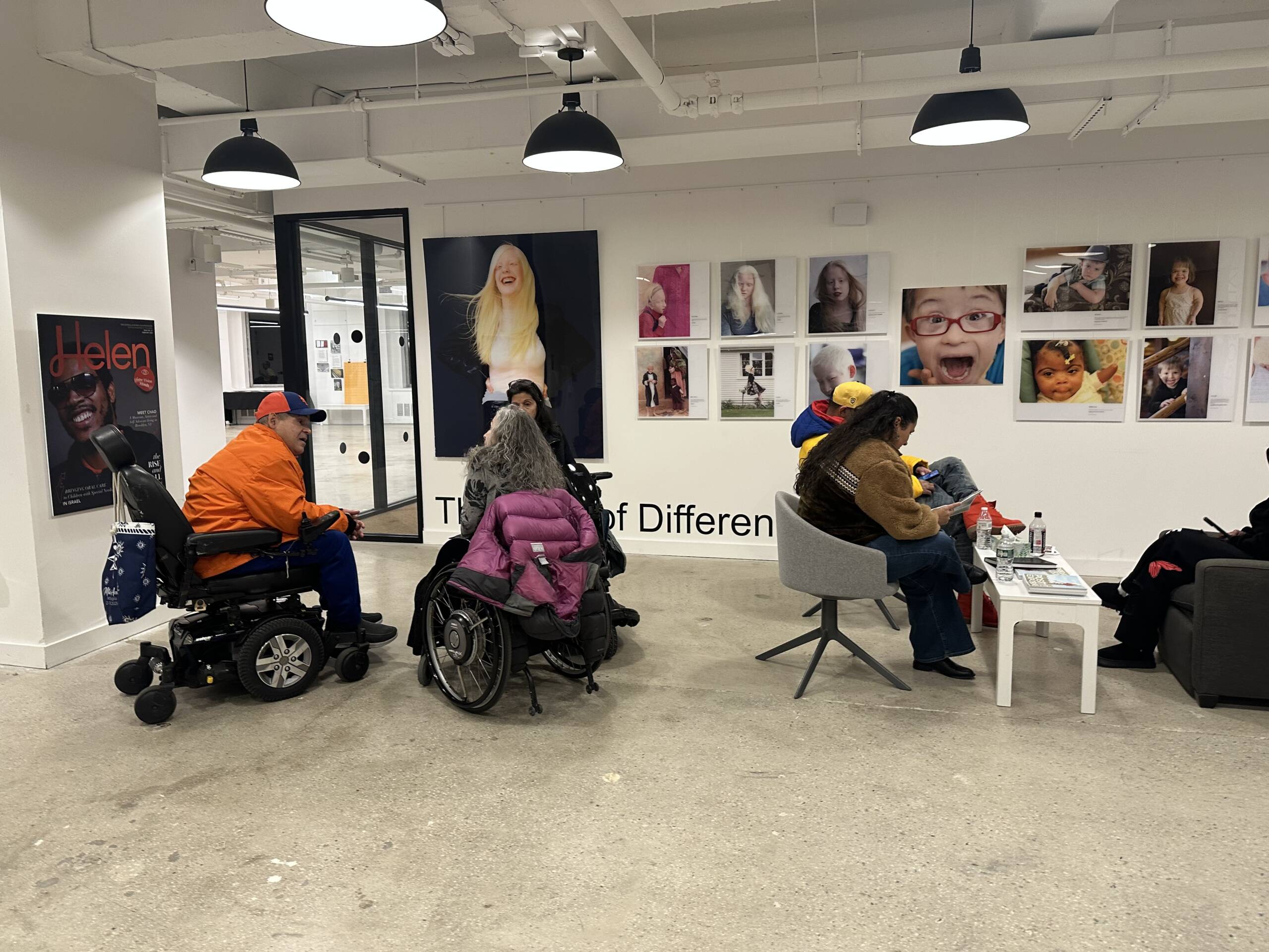 Guests admiring the photography near the entrance of the Positive Exposure Gallery