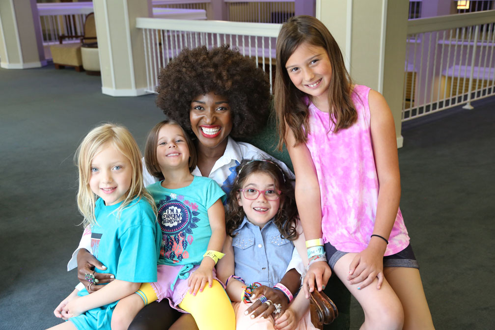 group of 5 women smiling intothe camera