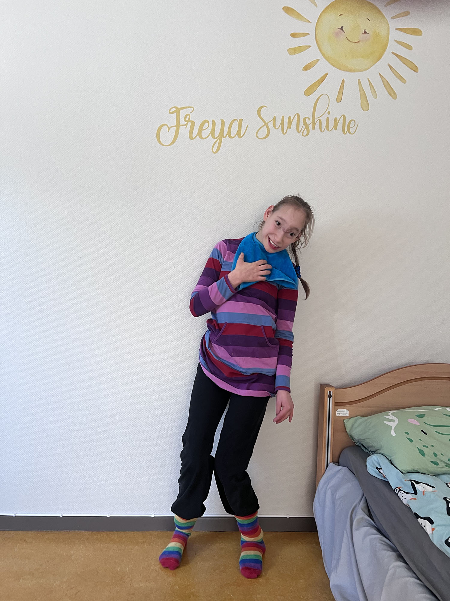 Young lady standing under a wall sign "Freya Sunshine"